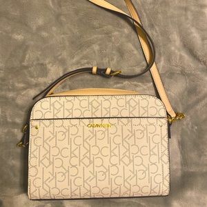 Cream and Light Pink cross body Calvin Klein 5 pocket purse.